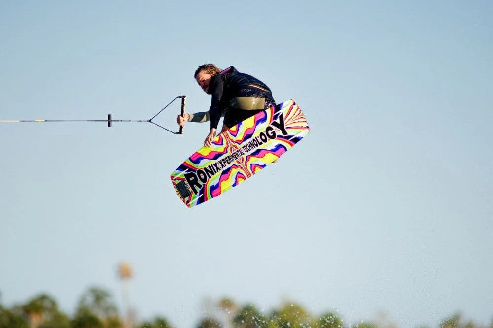 Ronix wakeboard mid-air, showing the board's rocker line